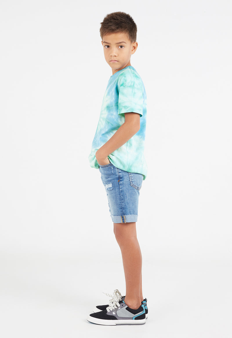 Side view as the young boy wears the Boys Aqua and Mint Spiral Tie-Dye T-Shirt by Gen Woo 