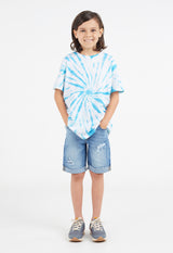 The young boy wears the Boys Blue and White Tie-Dye T-Shirt by Gen Woo with denim shorts and sneakers