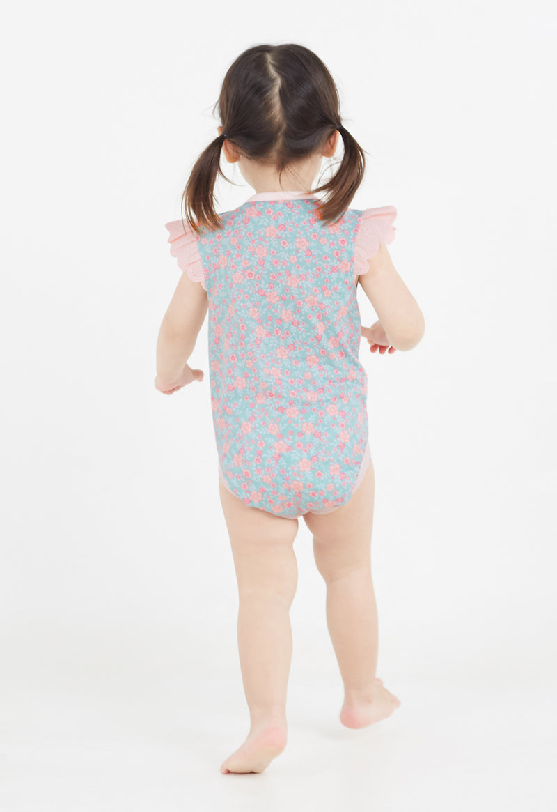 Back view of the young girl wearing the Ditsy Floral Print Flutter Sleeve Vest by Gen Woo