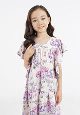 Close-up of the young girl wearing the Pink and Purple Floral Bloom Tiered Girls Dress by Gen Woo