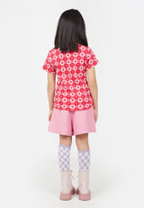 Young girl wears the Retro Floral Print Pink Checkerboard Girls T-Shirt by Gen Woo