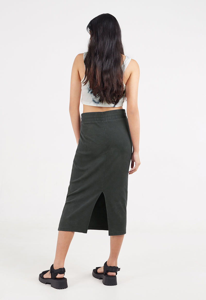 Back view as the model wears the Ladies Drawstring Waist Ribbed Midi Skirt by Gen Woo