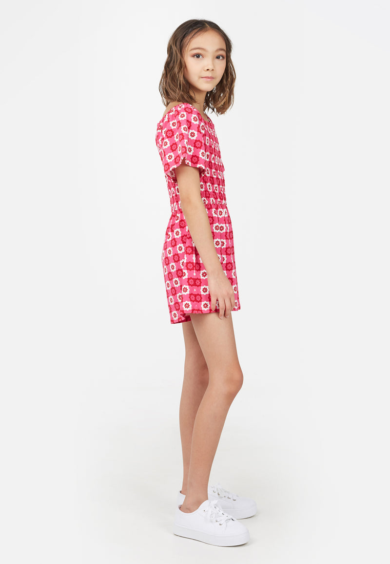 Side profile of the teenage girl wearing the Retro Floral Print Pink Checkerboard Girls Playsuit by Gen Woo