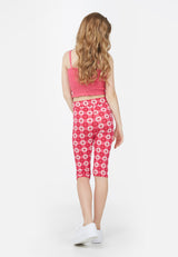 Back view of the teenage girl in the Pink Checkerboard Retro Floral Print Girls Leggings by Gen Woo