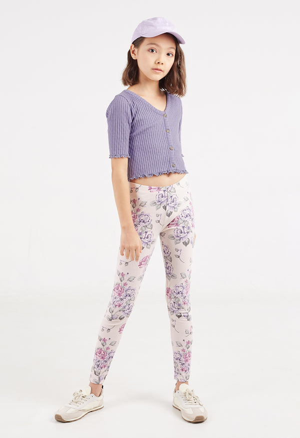 The young girl wears the Everyday Girls Floral Print Leggings by Gen Woo with a cropped purple top and hat