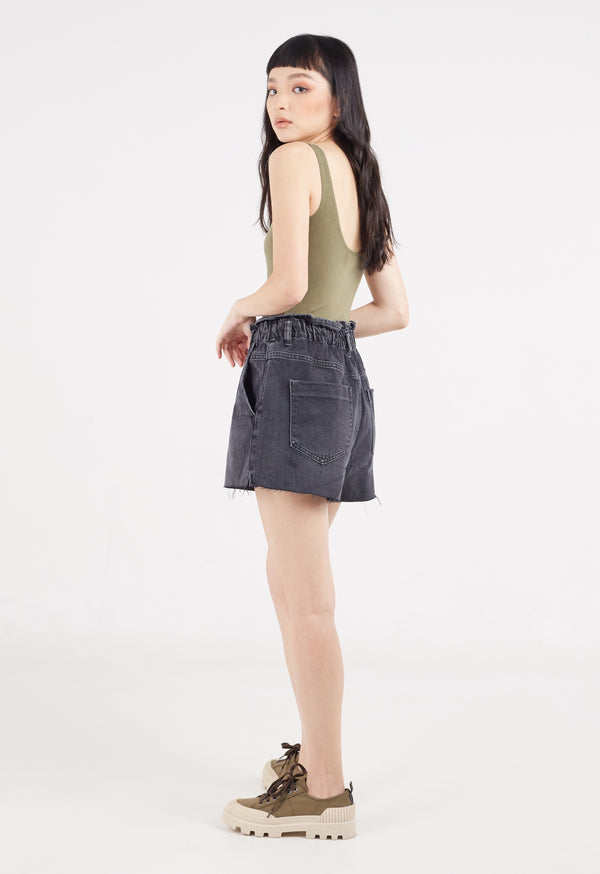 The model wears the Ladies V-Neck Khaki Bodysuit by Gen Woo with oversized denim shorts