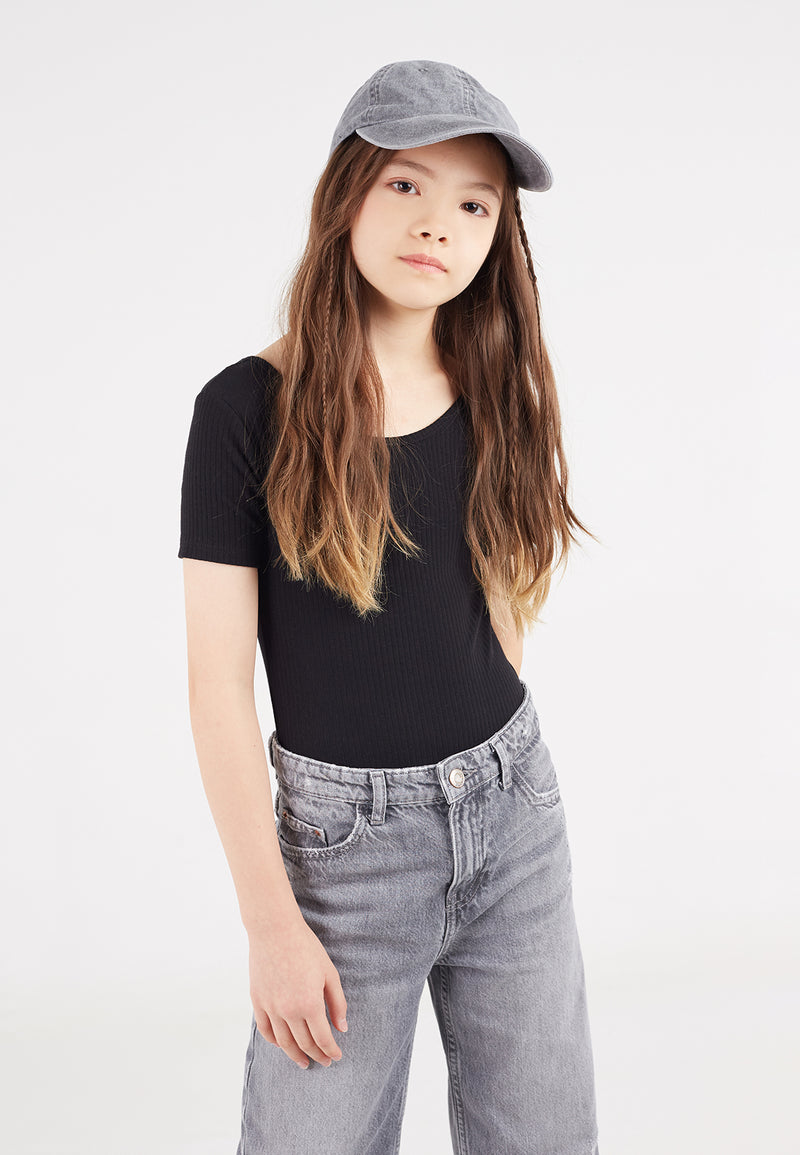Close-up of the teen girl wearing the Black Ribbed Short Sleeve Girls Bodysuit by Gen Woo