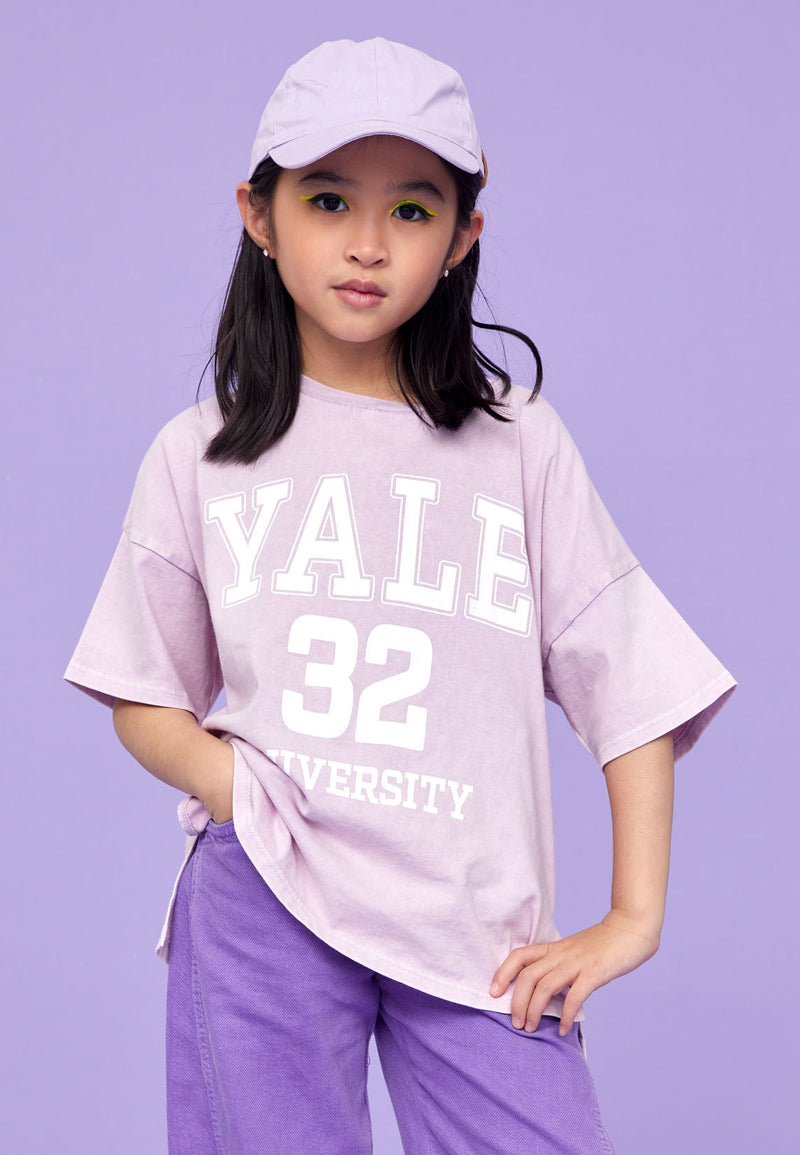 Model wears Teen Lavender Varsity T-Shirt by Gen Woo.