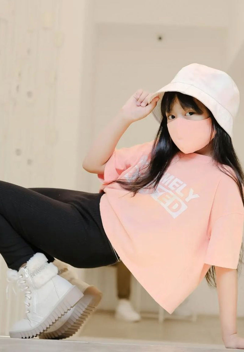 The teen girl poses wearing the Pink “Extremely Talented” Slogan Girls Boxy Cropped T-Shirt by Gen Woo