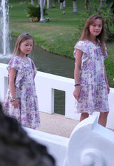 Both girls wear the Pink and Purple Floral Bloom Tiered Girls Dress by Gen Woo