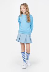 The young girl wears the Girls Crew Neck Blue Sweater by Gen Woo
