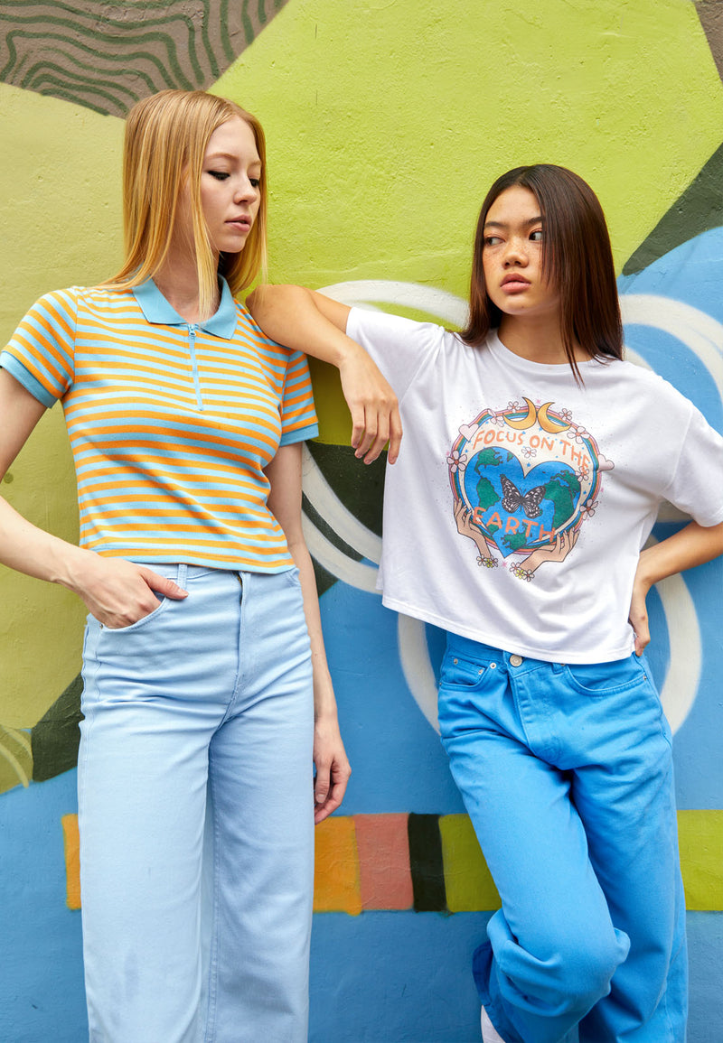 The model on the left wears the Blue and Orange Retro Striped Ladies Polo T-Shirt by Gen Woo