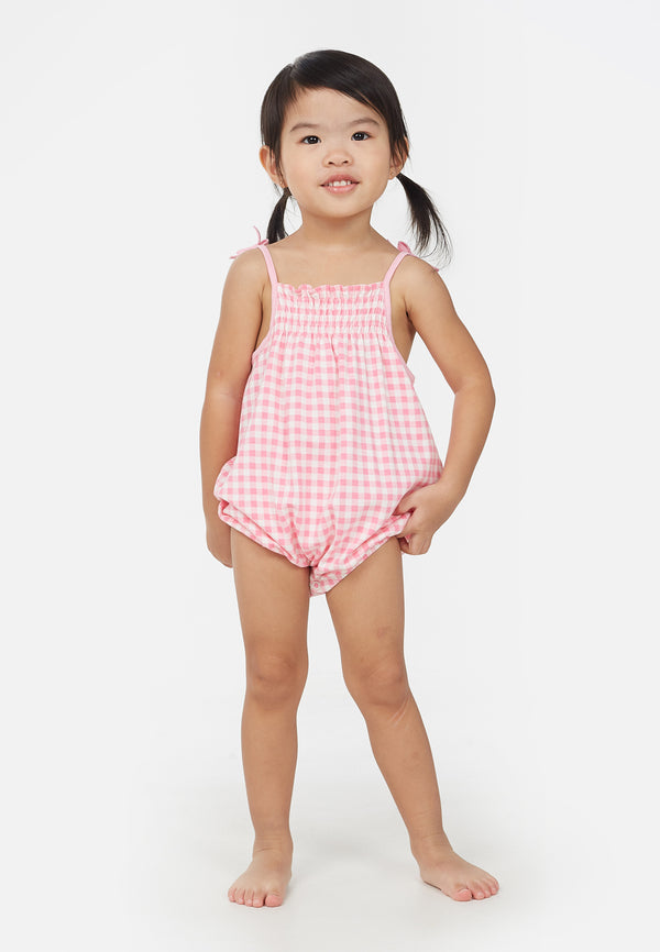 Little girl wears the Pink Gingham Check Baby Romper by Gen Woo