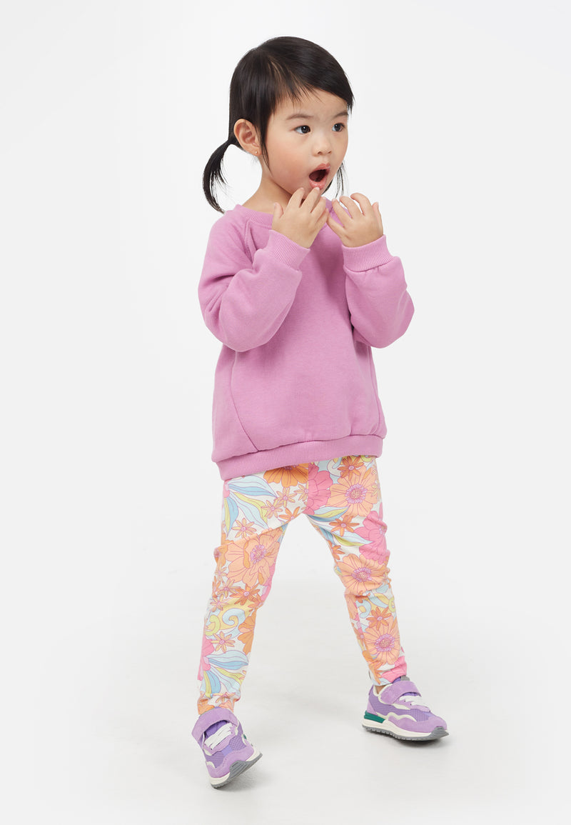 Little girl wears the Apricot and Pink Printed Floral Baby Leggings by Gen Woo