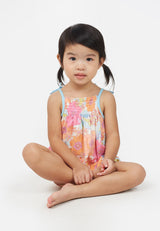 Little girl wears the Apricot and Pink Printed Floral Baby Romper by Gen Woo