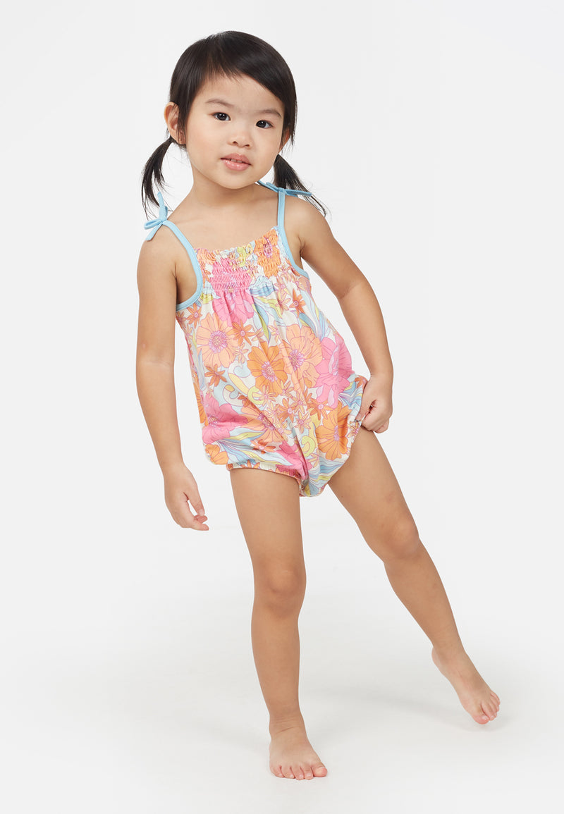 Little girl wears the Apricot and Pink Printed Floral Baby Romper by Gen Woo