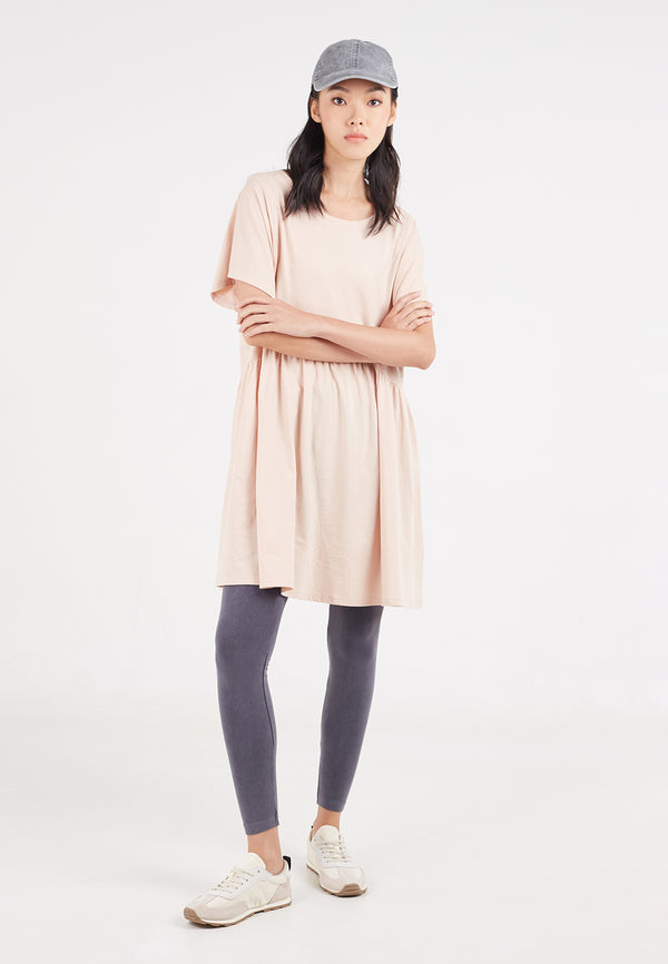 The model wears the Ladies Oversized Tunic Top by Gen Woo with leggings, trainers and a baseball hat