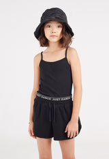 The young girl wears the Black “Just Dance” Girls Sweat Shorts by Gen Woo