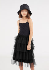 Close-up as the young girl wears the Black Tulle Girls Midi Skirt by Gen Woo