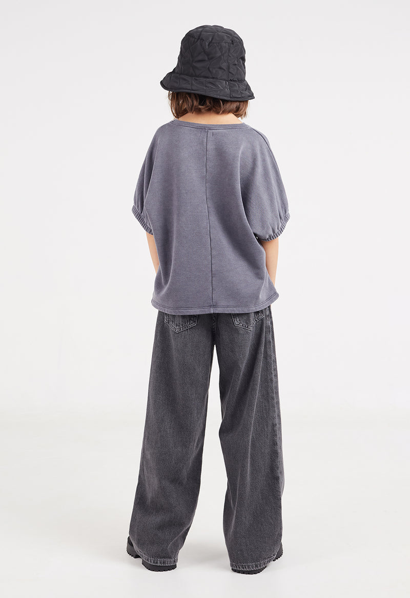 Back view of the young girl wearing the Washed Grey Boxy Girls Sweater T-Shirt by Gen Woo 