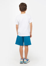 Back view of model wearing Blue Boys Bermuda Sweat Shorts by Gen Woo.