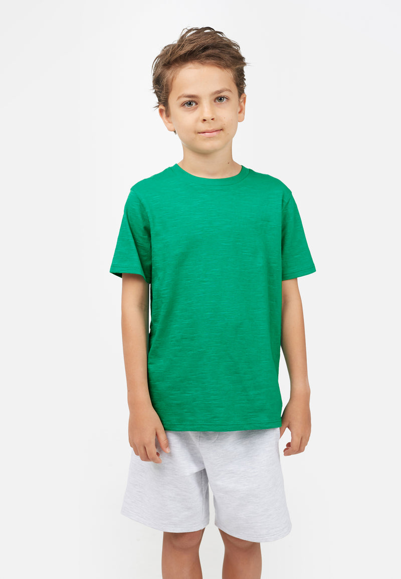 Model wears Emerald Green Boys Crew Neck T-Shirt by Gen Woo. 