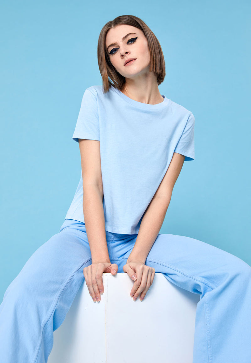 Model wears Basic Pastel Blue Ladies T-Shirt by Gen Woo. 