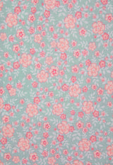 Close-up of the Ditsy Floral Print Long Sleeve Babygrow by Gen Woo