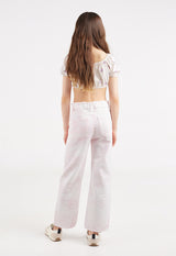 Back view of the young girl wearing the Girls Off-The-Shoulder Ditsy Crop Top by Gen Woo