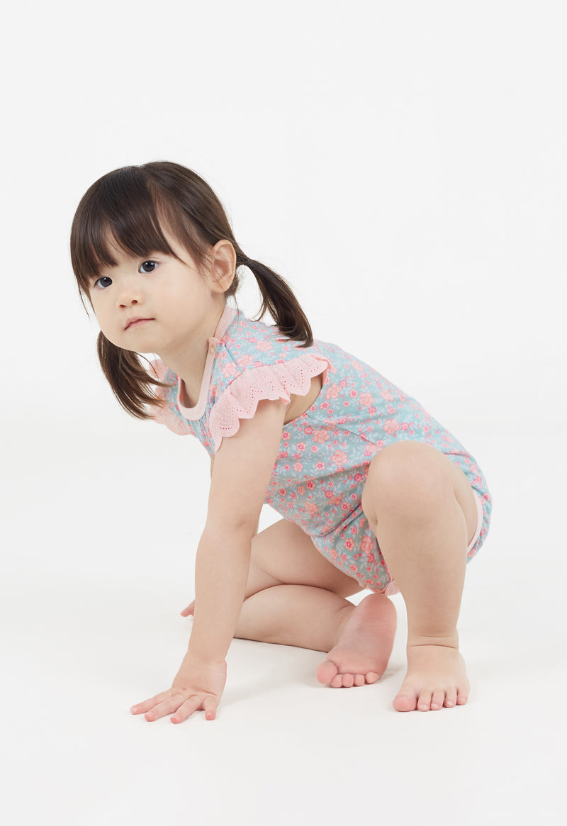 The young girl crawls wearing the Ditsy Floral Print Flutter Sleeve Vest by Gen Woo