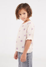 Model poses in Girls Ditsy Floral Frill Top by Gen Woo.