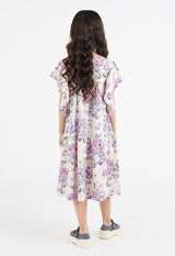 Back view of the young girl wearing the Pink and Purple Floral Bloom Tiered Girls Dress by Gen Woo