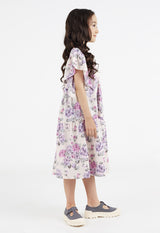Side profile of the young girl wearing the Pink and Purple Floral Bloom Tiered Girls Dress by Gen Woo
