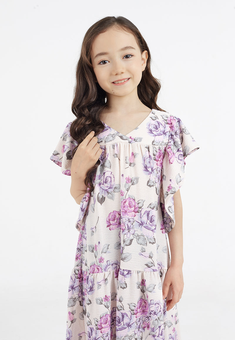 Close-up of the young girl wearing the Pink and Purple Floral Bloom Tiered Girls Dress by Gen Woo