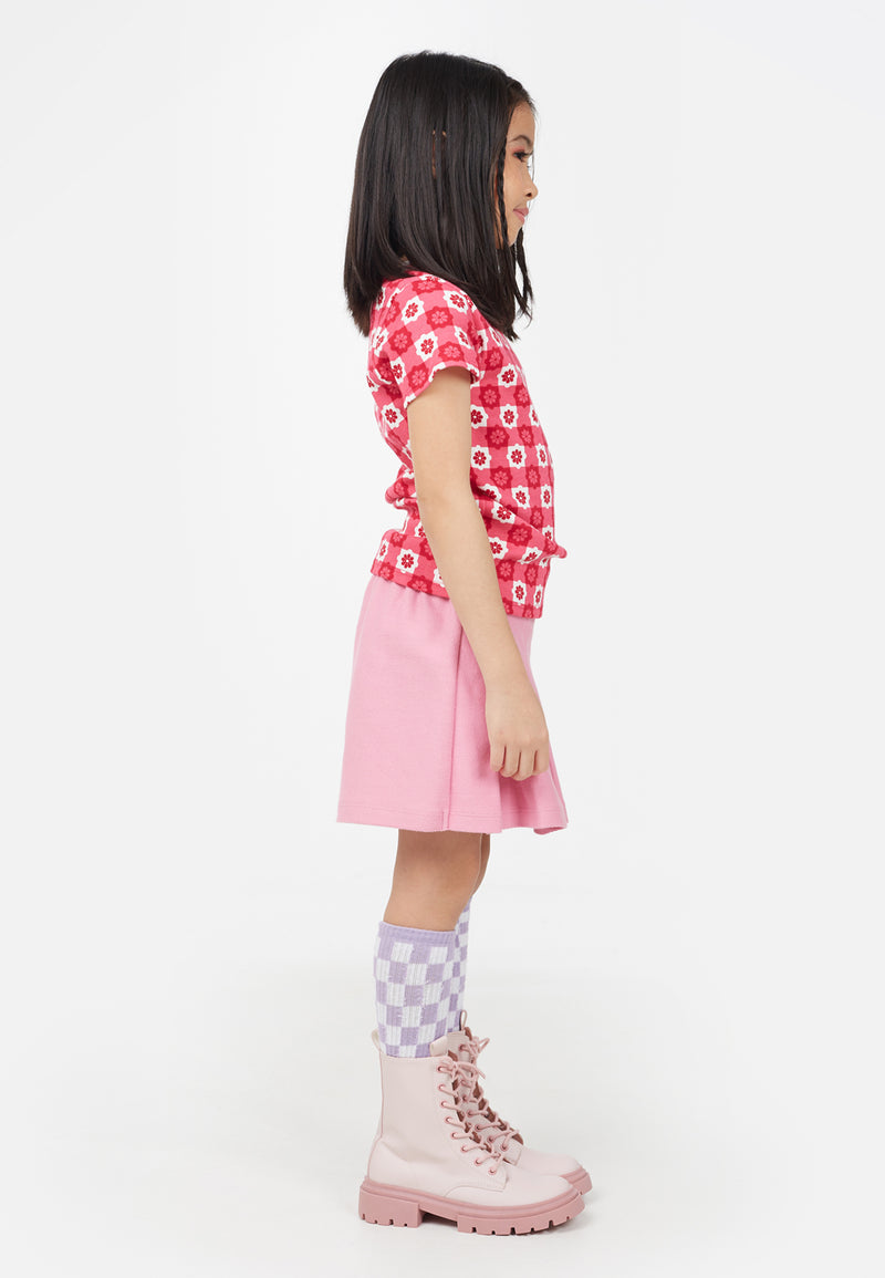Young girl wears the Retro Floral Print Pink Checkerboard Girls T-Shirt by Gen Woo