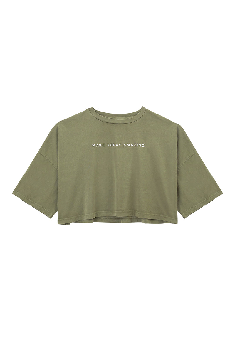 Ladies T-shirt by Gen Woo. Our “Make Today Amazing” slogan t-shirt is wide boxy fit and cropped above the belly button. The coriander coloured t-shirt features washed out effect. Please note that each washed out garment have colour shade variation. – Front view