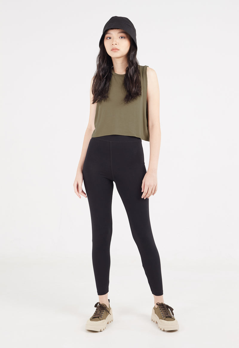 Ladies Vest by Gen Woo. Our coriander coloured vest is cropped length to mid waist. The vest has drapey and loose fit. Styled as a layering top for a sporty look. –Front view