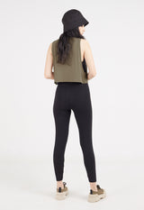 Ladies Vest by Gen Woo. Our coriander coloured vest is cropped length to mid waist. The vest has drapey and loose fit. Styled as a layering top for a sporty look. –Back view