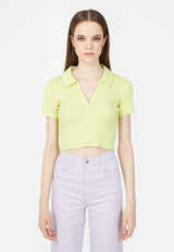 Model wears 90's inspired Ladies Lime Green Cropped Polo T-Shirt by Gen Woo. 