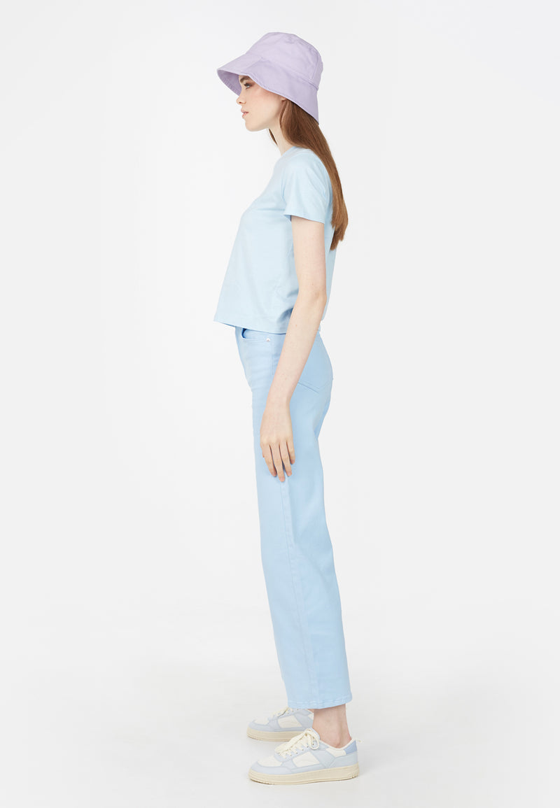 Side view of model wearing Basic Pastel Blue Ladies T-Shirt by Gen Woo. 