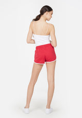 Back view of the model in the Red and White Retro Ladies Track Shorts by Gen Woo