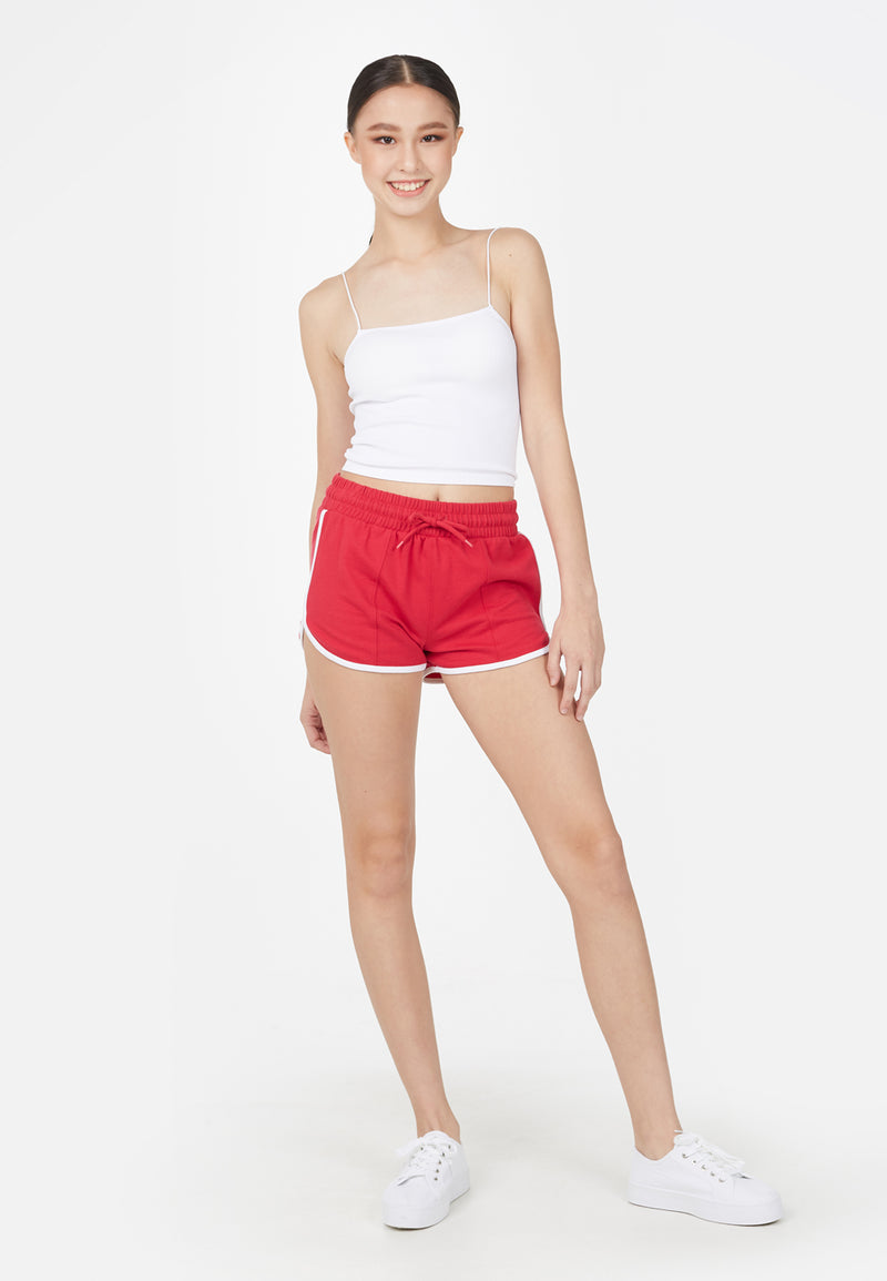 The model wears the Red and White Retro Ladies Track Shorts by Gen Woo