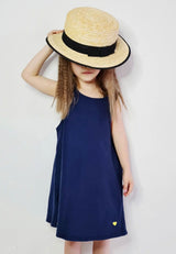 Young girl wears the Navy Blue Twill Pinafore Dress by Gen Woo