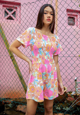 Close up as the teen girl models the Retro Floral Girls Jumpsuit by Gen Woo
