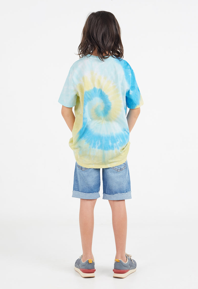 Back view as the young boy wears the Boys Blue and Yellow Spiral Tie-Dye T-Shirt by Gen Woo 