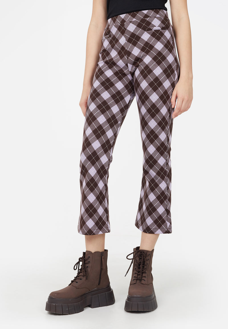 Close up as the teen girl wears the Plaid Flare Crop Trousers by Gen Woo with chunky boots