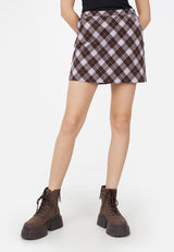 A close-up of the teenage girl wearing the Purple Plaid Girls Mini Skort by Gen Woo