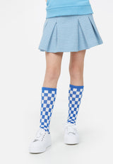 Model wears blue check tube socks and Teen Blue Check Jacquard Skort by Gen Woo.