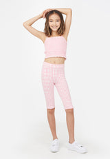 Teenage girl poses in the Gingham Shirred Strappy Girls Crop Top by Gen Woo