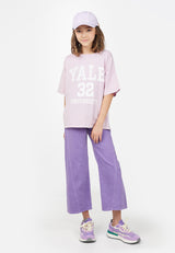 Model wears oversized Teen Lavender Varsity T-Shirt by Gen Woo. 
